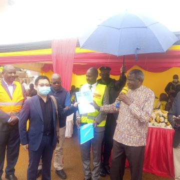 Minister Obiga handing over Certificate to CICO Boss